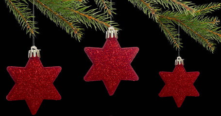 Image of christmas tree with red stars and fairy lights flickering over black background