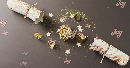 Image of christmas greetings text over christmas cracker decorations © vectorfusionart