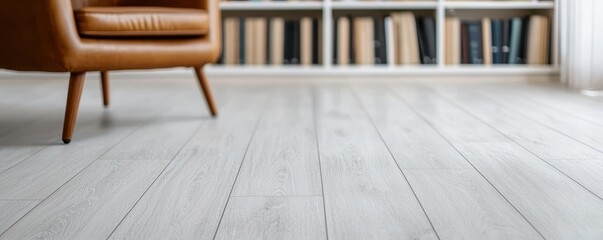 Flooring vinyl maintenance concept. Cozy interior space featuring a wooden floor, stylish armchair, and bookshelves filled with books.