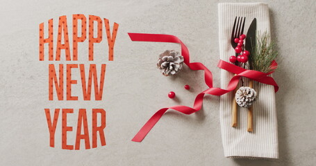Image of christmas greetings text over christmas place setting and decorations