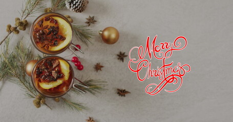 Image of christmas greetings text over christmas decorations