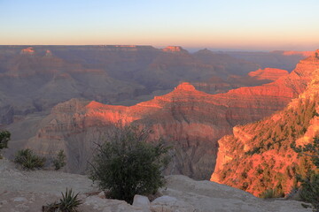 The last rays of the summer sun shine on the upper reaches of the canyon as seen from Yavapai Point on the South Rim in Arizona, USA