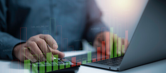 Businessman operating a calculator and laptop with digital bar charts and financial data overlays....