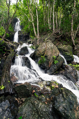Stunning Diguisit Falls in Aurora cascading down moss-covered rocks in a lush, green forest. The surrounding vegetation and rugged terrain enhance the beauty of this peaceful and refreshing scene.