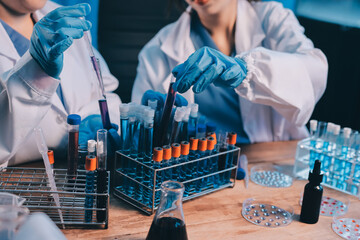 Blood test in the laboratory. Laboratory assistant working with the dispenser. Vacuum tubes with...