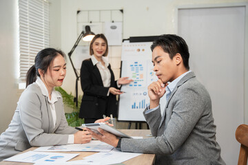 Asian business Talk about new projects, presents at home office.

