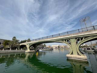 Fototapeta premium A vibrant snapshot of Riverland Dubai, where charming cobblestone streets, picturesque bridges, and scenic waterways transport you to a world of timeless charm. Lush greenery and European-style.