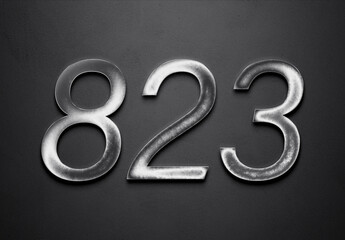 Chrome metal 3D number design of 823 on grey background.