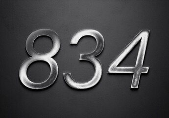 Chrome metal 3D number design of 834 on grey background.