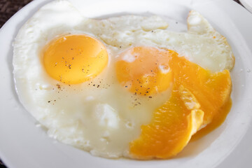 Delicious fried eggs with vibrant orange yolks.