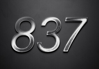 Chrome metal 3D number design of 837 on grey background.