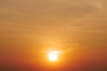 Stunning Golden Sunset Over Tranquil Horizon with Soft Clouds and Warm Light Creating a Serene and Peaceful Atmosphere