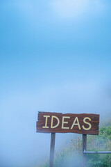 wooden signpost misty landscape