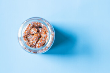 Dietary supplement with bottle on blue background, Multivitamin tablets on blue background, Dietary...