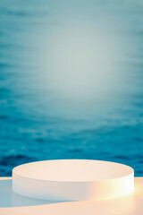 white cylindrical platform against a blurred blue water background
