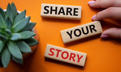 Share your story symbol. Wooden blocks with words Share your story. Beautiful orange background...