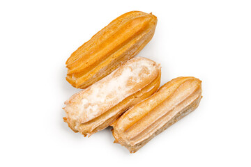 Three eclairs with custard cream on a white background. Fresh sweet pastries.
