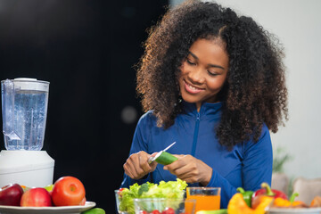 Fit happy black woman enjoys healthy fruit breakfast after yoga training. fitness, nutrition, home lifestyle.