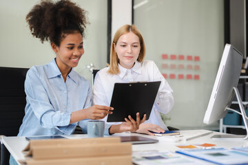 Diverse professionals collaborate on project analysis with financial graphs. Strategic teamwork and...