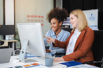 Diverse professionals collaborate on project analysis with financial graphs. Strategic teamwork and...