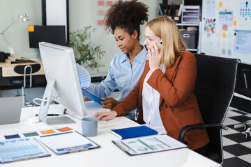 Diverse professionals collaborate on project analysis with financial graphs. Strategic teamwork and insights drive company growth and success.