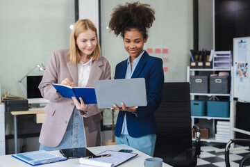 Diverse professionals collaborate on project analysis with financial graphs. Strategic teamwork and...