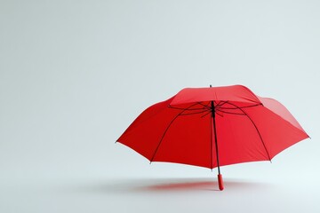 Obraz premium Bright red umbrella stands alone against a plain white background, emphasizing simplicity and elegance in design
