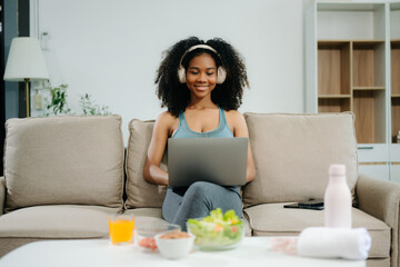 A fit woman enjoys a fresh salad with fruits and juice, embodying wellness, nutrition, and vitality i