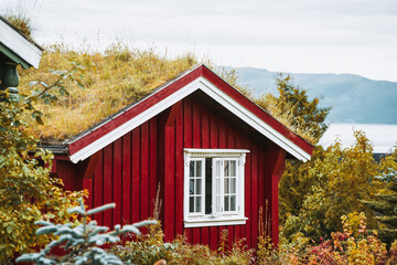 Autumn scenery with red house by fjord