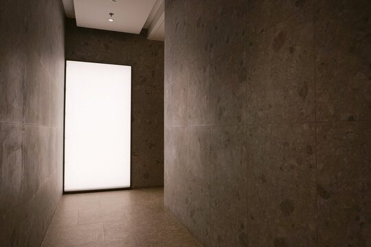 Dark Hallway with a Bright Light at the End. Abstract Interior with Contrasting Light and Shadow. Suitable for more artistic or design oriented contexts.