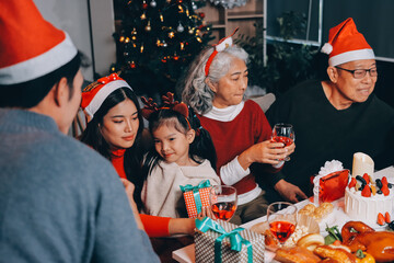 Happy family with gifts celebrating Christmas together