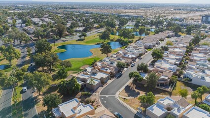 Aerial view of suburban neighborhood with parks and lakes.