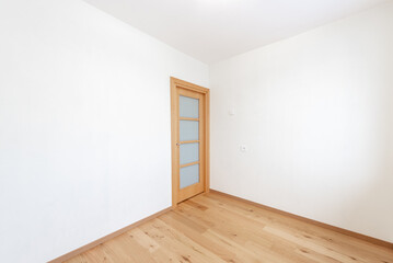 Minimalist Empty Room With Wooden Floor and Closed Wooden Door. Home Interior