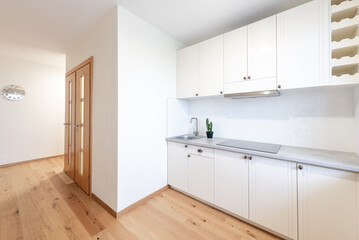 Modern White Kitchen Interior with Large Window and Wooden Flooring. Home Interior
