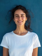 Fototapeta premium Woman standing against blue wall