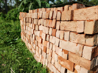 Stack of Bricks on a Field: A Rustic Touch to Construction and Nature