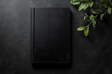 Black book mockup on dark background with green leaves. (1)