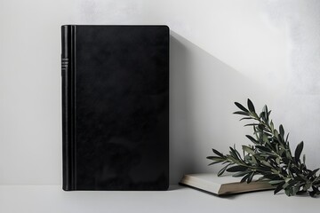 Black notebook mockup with olive branch and book.