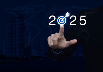 Businessman pressing 2025 letter with goal icon over world map, modern city tower and skyscraper, Business happy new year 2025 success concept, Elements of this image furnished by NASA