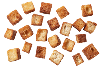 Crunchy golden croutons scattered on a white background ready for salads and soups