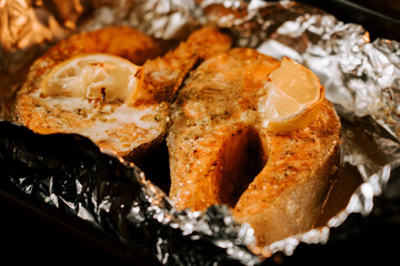Perfectly baked trout steak with lemon, a delicious fire-cooked dish ready to savor