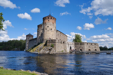 The Scandinavian castle is surrounded by water.