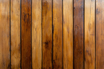 Fototapeta premium Polished wooden wall with vertical slats, showcasing rich textures and warm tones. This natural wood surface adds rustic charm to any space