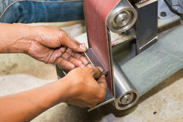 The metal deburring process by abrasive sand paper belt.