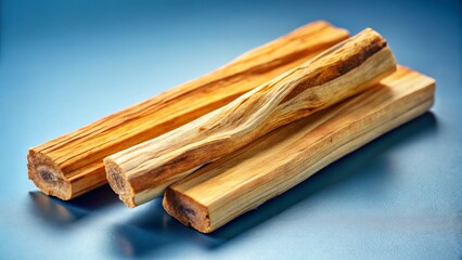Close-up of Three Palo Santo Sticks on Light Blue Background - Aromatic Incense