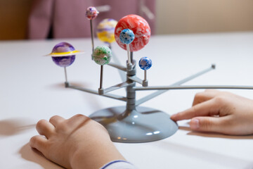 Preschooler child is making a solar system project