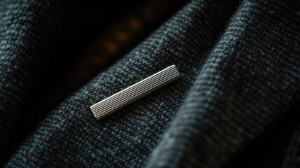Elegant Silver Tie Clip on Soft Textured Fabric Background
