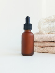 A small Mocha Muse jar with a pipette and a towel and a hair clip. Hair growth serum. Shampoo against dandruff.