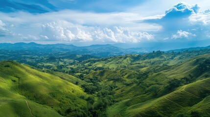 Fototapeta premium Vibrant landscape showcasing lush green hills under a dramatic blue sky with fluffy white clouds in a serene natural setting