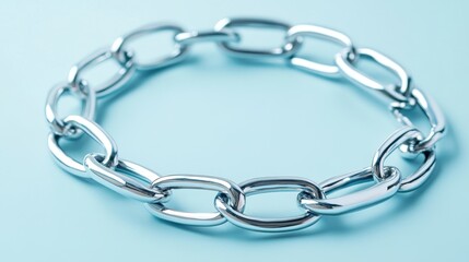 Obraz premium Shiny Silver Chain Link Bracelet on Soft Blue Background